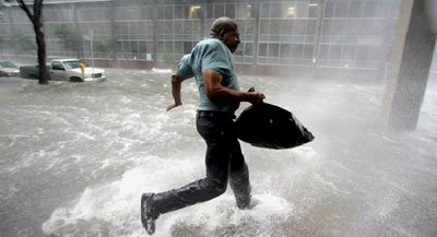 A Hurricane Katrina survivor runs to safety