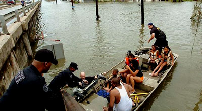 New Orleans Police officers assist Hurricane Katrina survivors