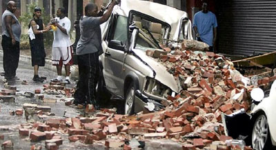 Hurricane Katrina Survivors view a destroyed vehicle