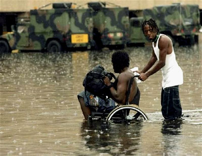 Two Hurricane Katrina survivors wade
through the flood