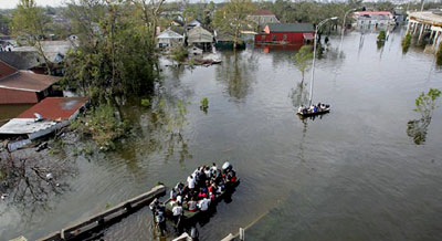 Hurricane Katrina survivors transport themselves with boats