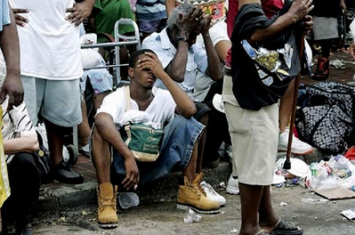 Despair: An exhausted and distraught Katrina survivor waits for help
