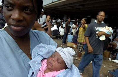 A Hurricane Katrina survivor comforts her baby